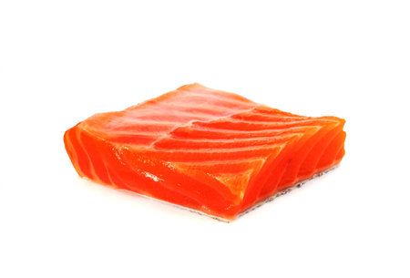 Piece of fresh salmon fillet sliced isolated on white backgroundの写真素材