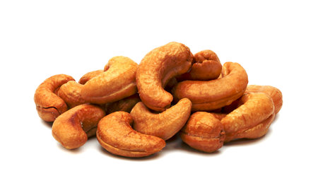 Roasted cashew nuts isolated on white backgroundの写真素材