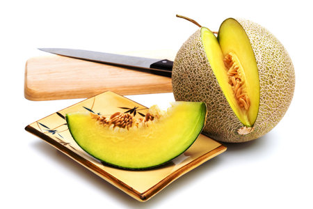melon on cutting board isolated on white backgroundの写真素材