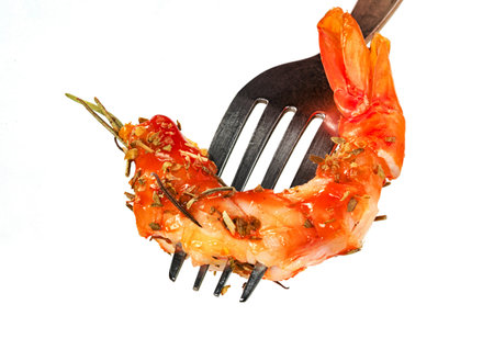 roasted peeled prawn and oregano and tomato sauce with fork isolated on white background ,grilled shrimpの写真素材