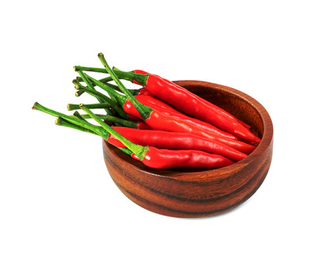 red fresh chili pepper with wooden bowl isolated on white backgroundの写真素材