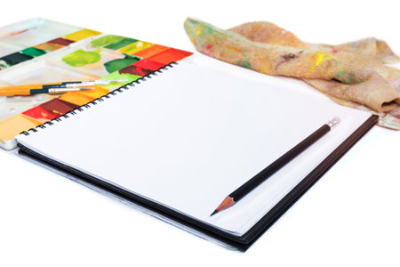 closeup open note book with tray colors on backgroundの写真素材