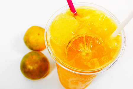 Slush ice with orange in Plastic Cup on background.の写真素材