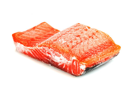 Piece of frozen salmon fillet sliced isolated on white backgroundの写真素材