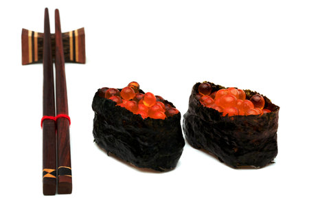 rolled sushi of salmon roe nigiri with wooden chopsticks isolated on white backgroundの写真素材