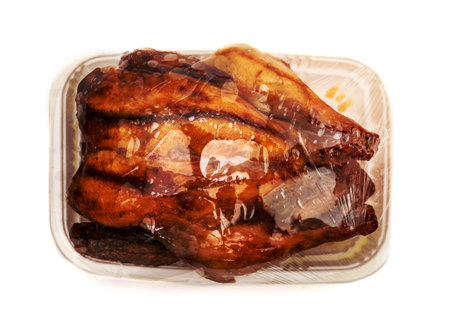 roasting chicken in plastic packaging,isolated on white backgroundの写真素材