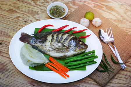 Steamed Nilotica fish,thai style steamed fish with vegetableの写真素材