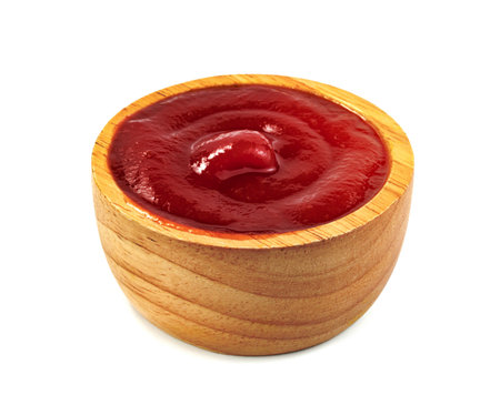 tomato sauce in wooden bowl isolated on white backgroundの写真素材