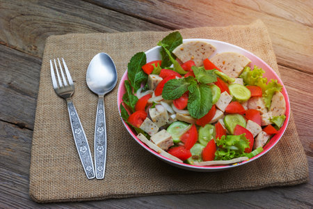 Thai cuisine spicy pork salad on wood background or Yum Moo Yorの写真素材