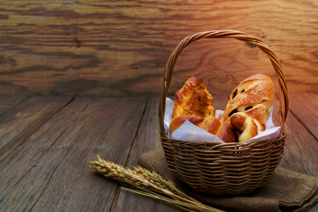 various fresh cheese sausage bread In the basket on wooden backgroundの写真素材
