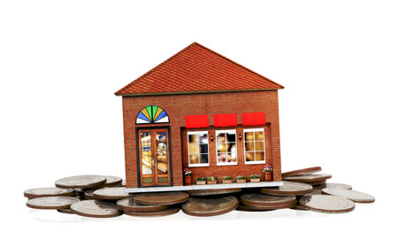 store model with piles of coins isolated on white backgroundの写真素材