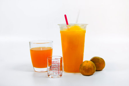 Slush ice with orange in Plastic Cup white background.の写真素材