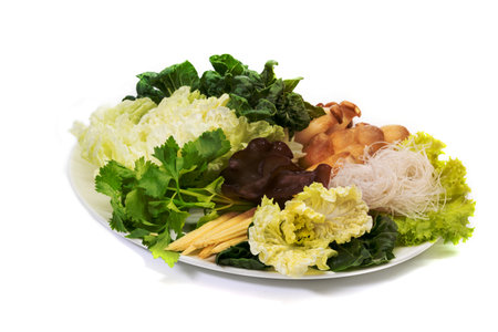 various fresh vegetables for sukiyaki on white dish, isolated on white backgroundの写真素材