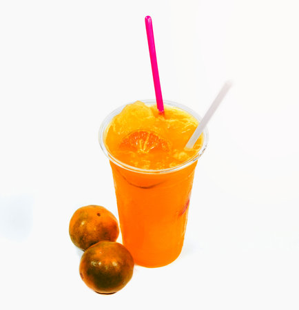Slush ice with orange in Plastic Cupon white background.の写真素材