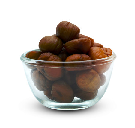 peeled roasted chestnut in glass bowl isolated on white background ,include clipping pathの写真素材