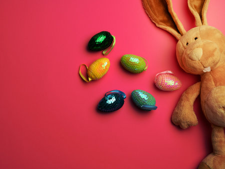 cute plush bunny with long ears, decorative egg, easter pink backgroundの写真素材