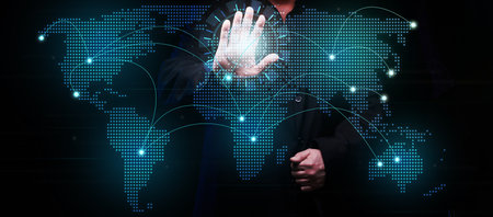 a businessman establishes communication and exchange of information between the continents on a virtual holographic map of the world. Global networkの写真素材