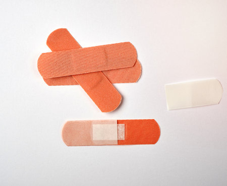 brown textile sticky patch for wounds on the skin of the body, white backgroundの写真素材