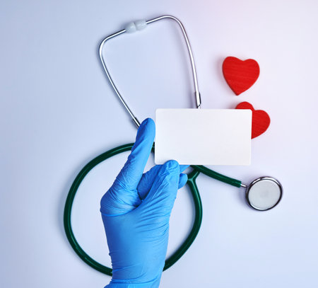 empty white paper card in doctor's hand, white background with stethoscopeの写真素材