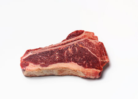 fresh raw piece of beef meat, striploin steakon white background, top view.  Marbled piece of meat New Yorkの写真素材