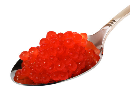 Red sturgeon caviar in a metal spoon on a white isolated background, delicious snackの写真素材