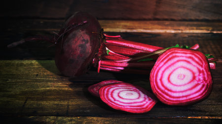 Fresh red beet sliced on brown wooden backgroundの写真素材