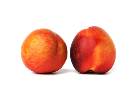 ripe round red nectarine isolated on white background, tasty and healthy fruit, close upの写真素材