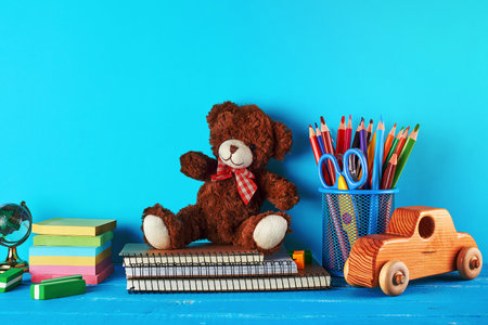 school supplies: notebook, pencils, stickers, scissors on a blue background, concept of back to schoolの写真素材