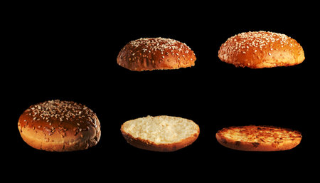 set of baked sesame seed buns: whole, halves and grilled halves, black background, close upの写真素材