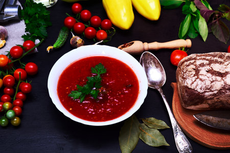 Gazpacho spanish cold soup in a white round ceramic plate on a black backgroundの写真素材