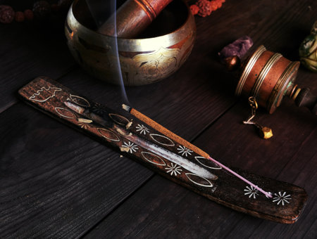 incense stick burning on a wooden stand, close upの写真素材