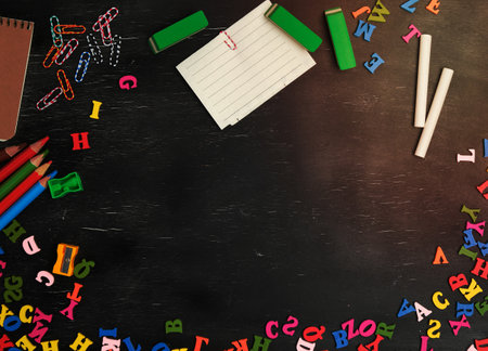 school supplies: multicolored wooden pencils, notebook, paper stickers, paper clips, pencil sharpener, copy spaceの写真素材