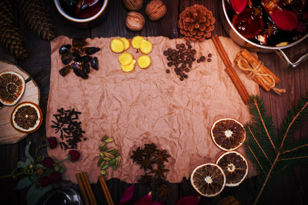 Ingredients and spices for cooking homemade alcohol mulled wine on brown kraft paper, empty space in the middleの写真素材
