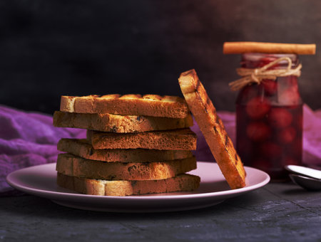 Fried square pieces of white wheat flour in a ceramic pink plate, close upの写真素材