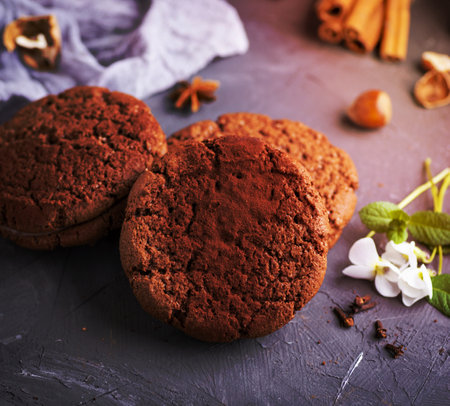 stack of baked round chocolate chip cookies on a black table, close upの写真素材