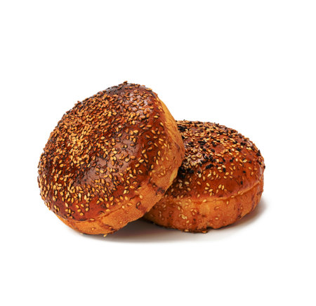 two baked sesame seed buns isolated on white background, hamburger breadの写真素材