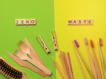 toothbrush, comb, clothespin and other wooden items on green background, top view, zero wasteの写真素材