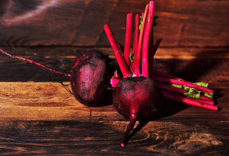 Two fresh beets on a brown wooden backgroundの写真素材