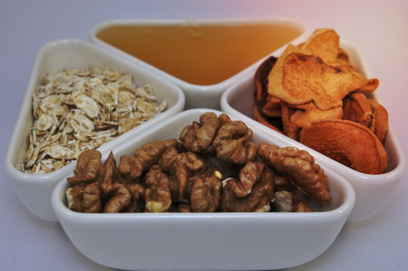 Nuts, honey, oatmeal and dried fruit for dietの写真素材