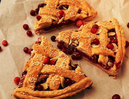 triangular slices of baked cranberry pie on brown paper, close upの写真素材