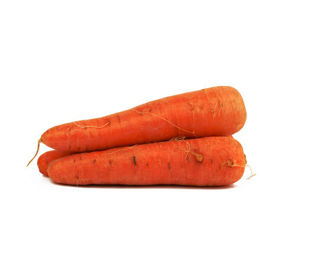 whole orange raw carrot isolated on white background. Delicious and healthy vegetable, close upの写真素材