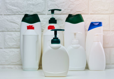 White plastic container with a pump for liquid products on a white shelf. Container for cosmetics, soap, creamの写真素材