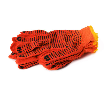 textile orange work gloves on a white background. Protective clothing for manual workers, close upの写真素材
