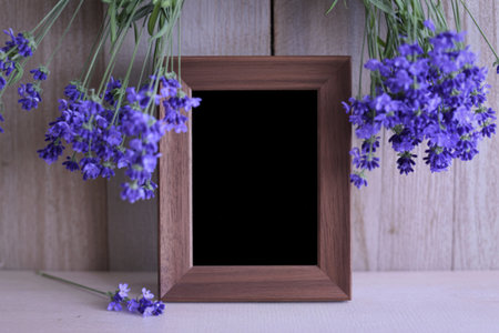 a rectangular wooden frame placed against a light wooden backgroundの写真素材