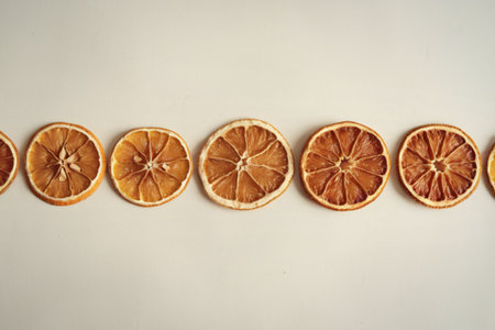 A photo of a fruit pattern of a row of dried orange slicesの写真素材