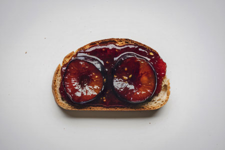 A photo of a bread slice with plum jamの写真素材