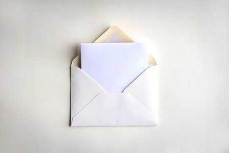 A photo of a white envelope with a blank white sheet of paper inside