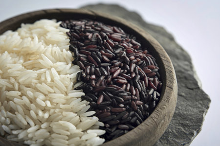 A photo of white and black rice in a wooden bowlの写真素材