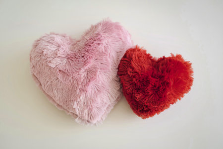 A photo of two heart-shaped objects with a plush, furry material