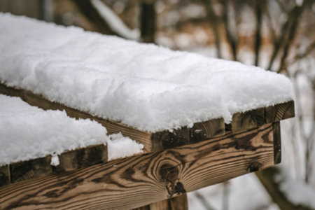 A photo of a rustic wooden surface with fresh snowの写真素材